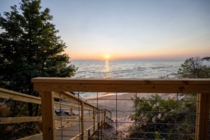 Four bedroom vacation rental home with private Lake Michigan access and steps down to the beach.