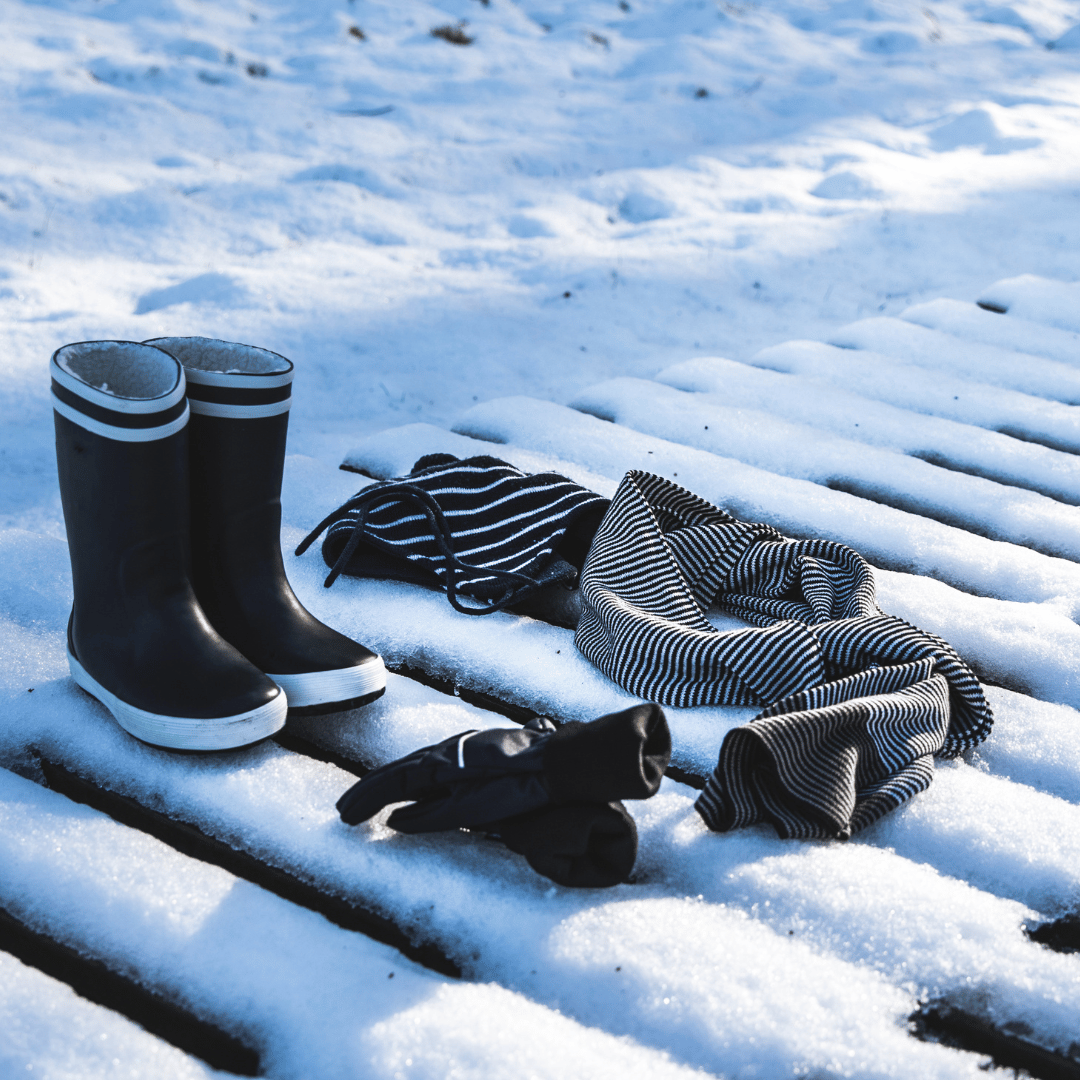 What to Pack for Vacation in Michigan: winter boots, hats, gloves, scarves, skis, and sleds