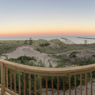 View of Lake Michigan, sand dunes, and beach grass from vacation home's private balcony