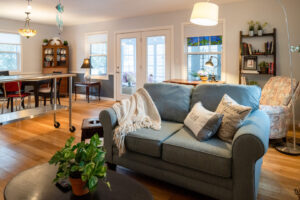 Interior view of furnished rental cottage's living room and dining area featuring a well-designed couch and living room area